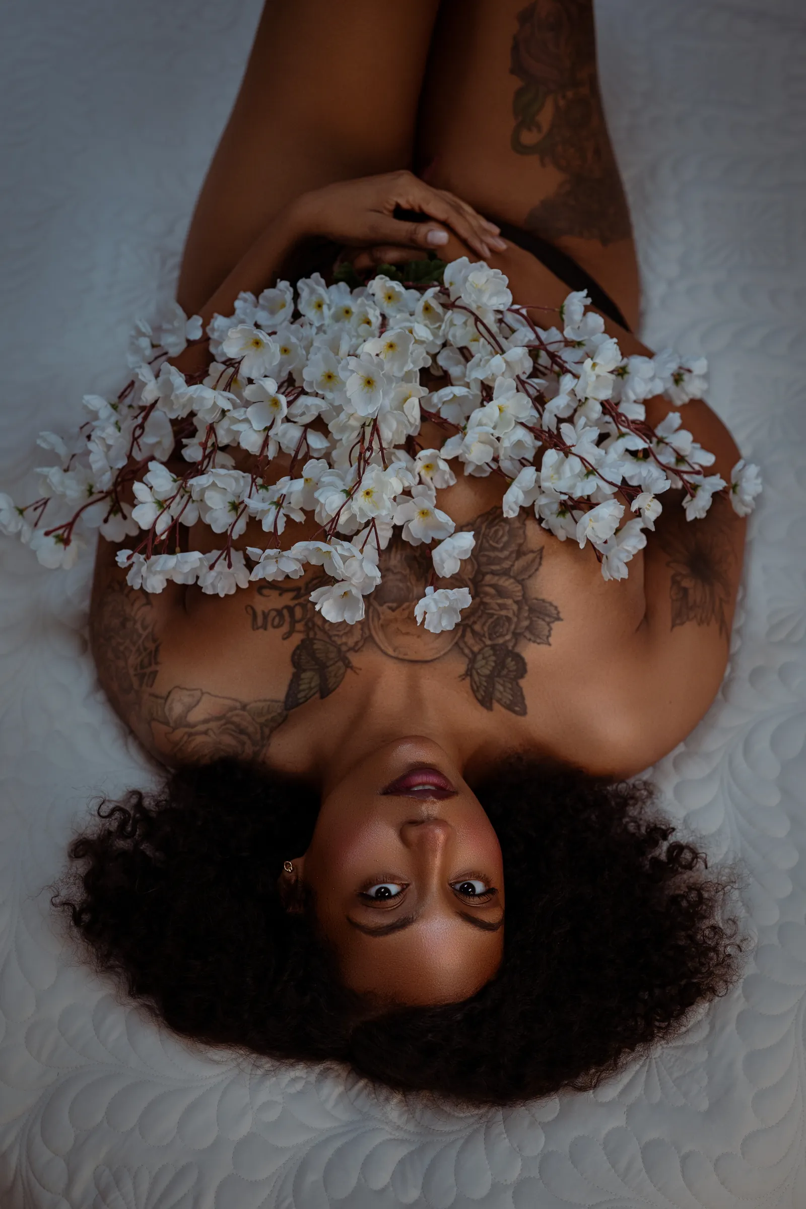 creative self love photoshoot concept with white flowers styled across the frame