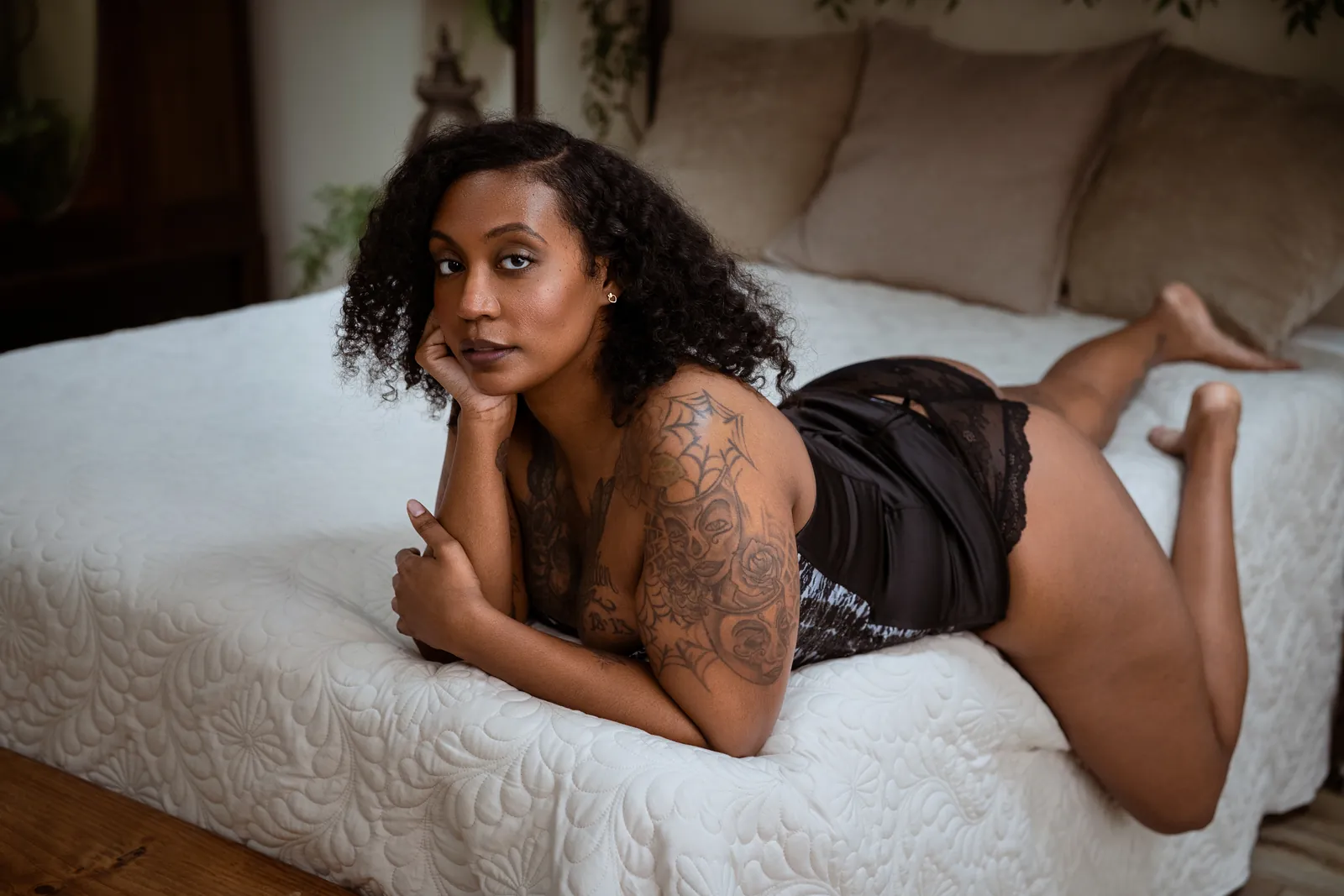 confident woman photographed on the studio bed during an empowerment photography session
