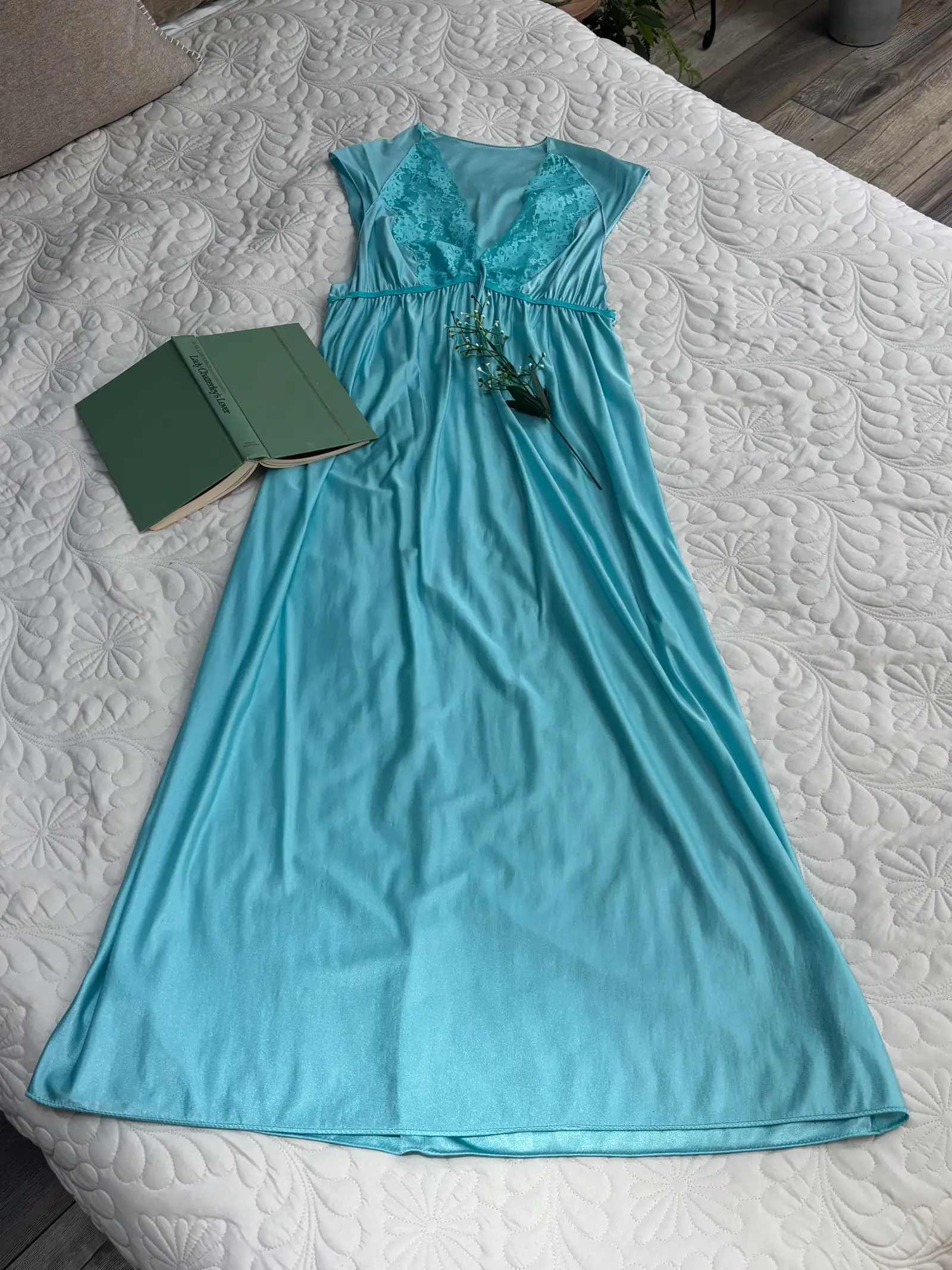 flowing dress laid out on the studio bed ahead of a women's empowerment photoshoot