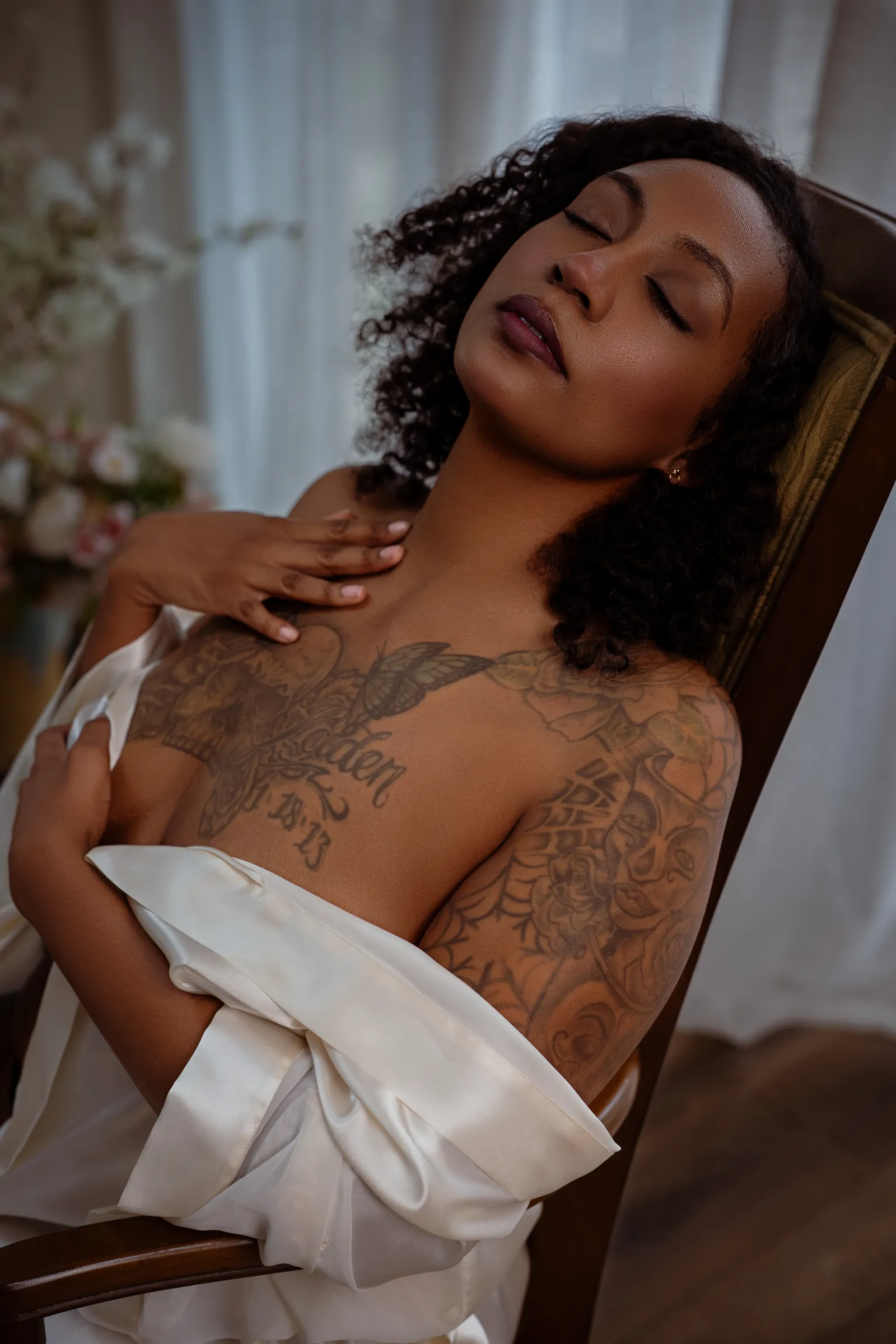 serene portrait of a woman draped in white satin during an empowerment photography session