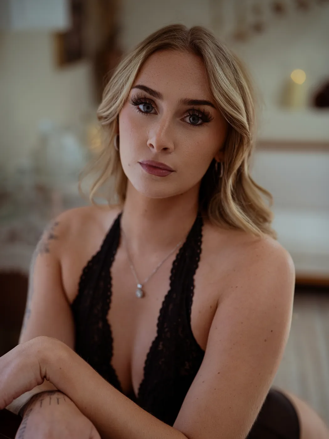 Seated boudoir portrait in black lace facing the camera